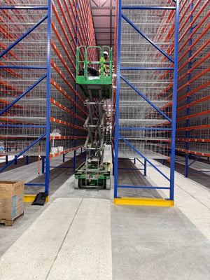 Warehouse rack label installation with scissor lift