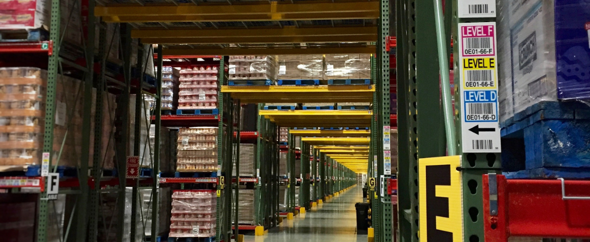 A rack tunnel in a warehouse with totem label